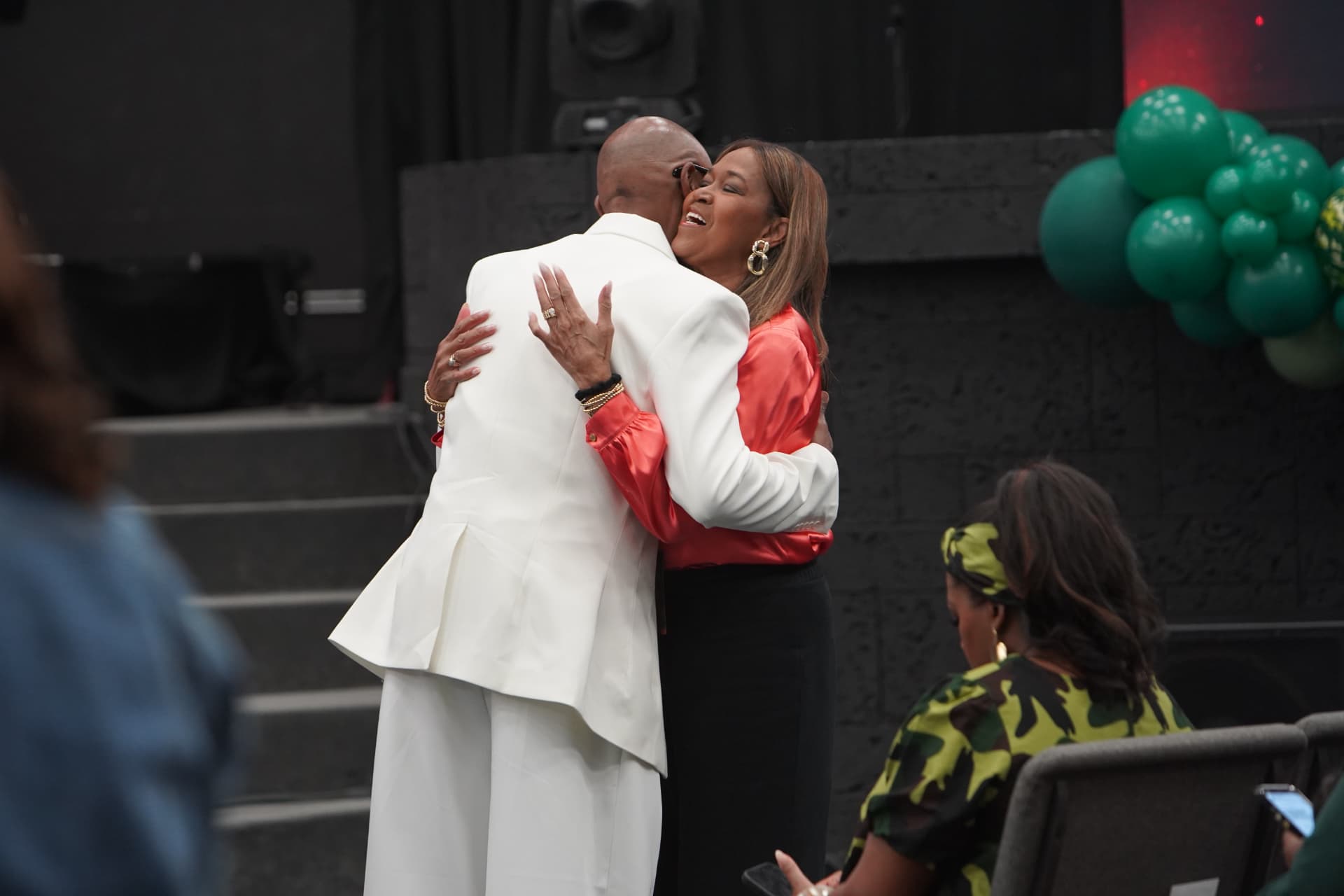 Two leaders embracing at the front of the sanctuary