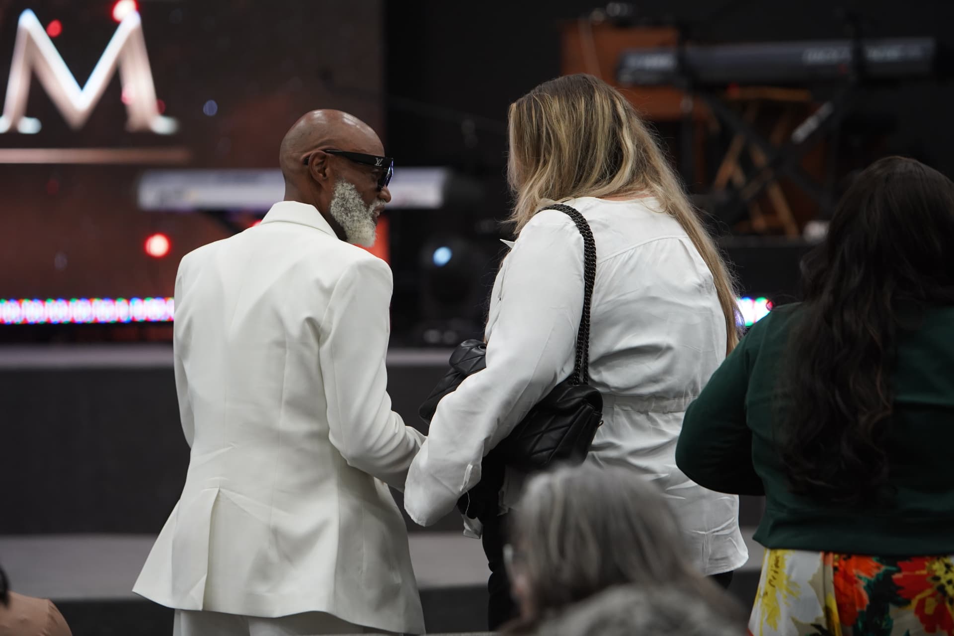 A couple standing together in worship during the gathering