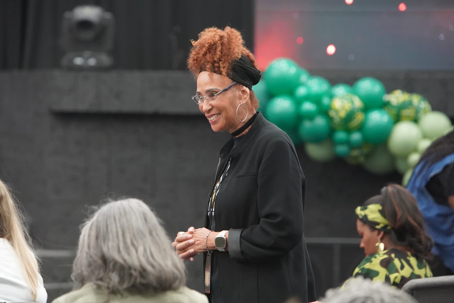A smiling leader greeting attendees in the sanctuary