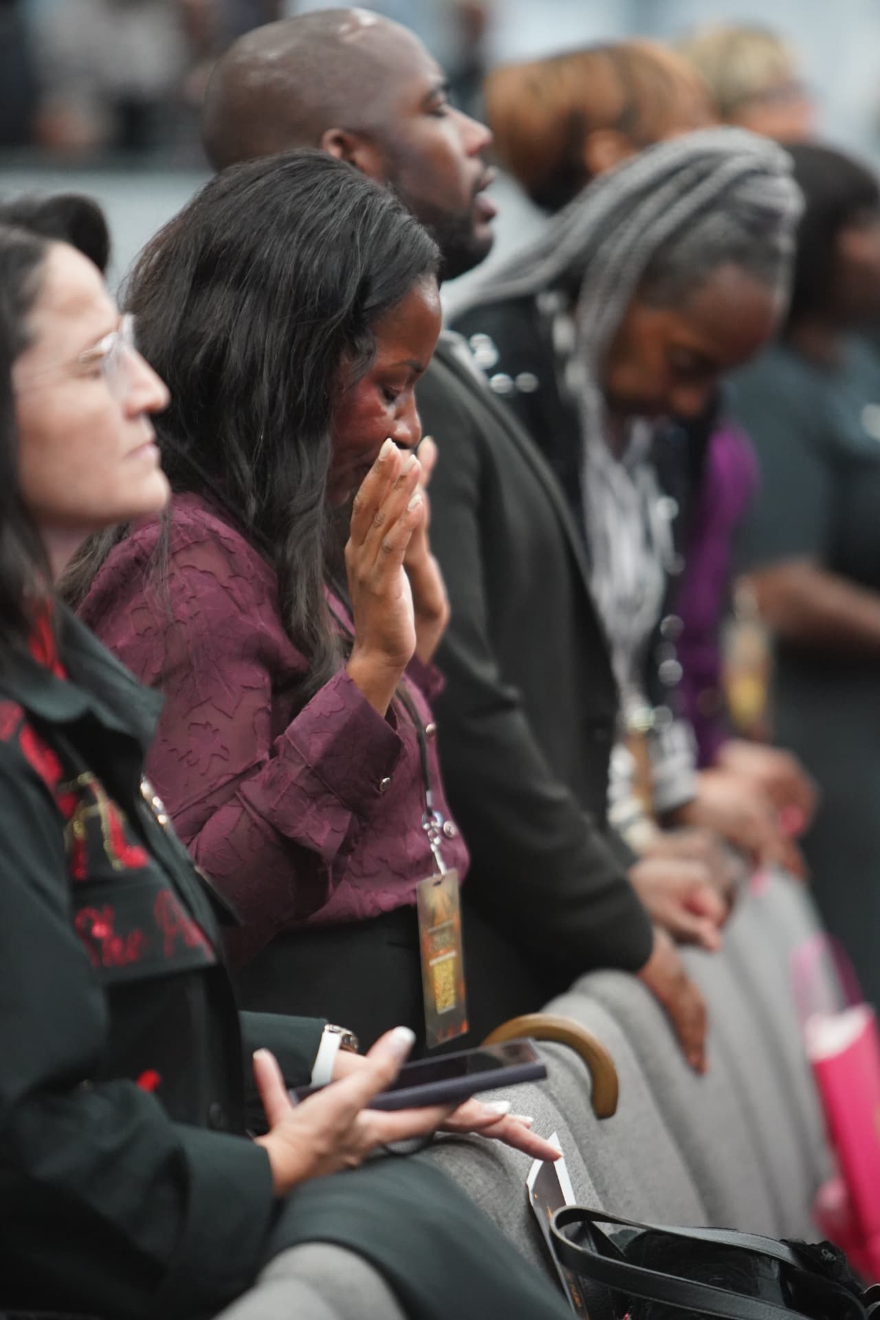 An attendee praying during a ministry moment